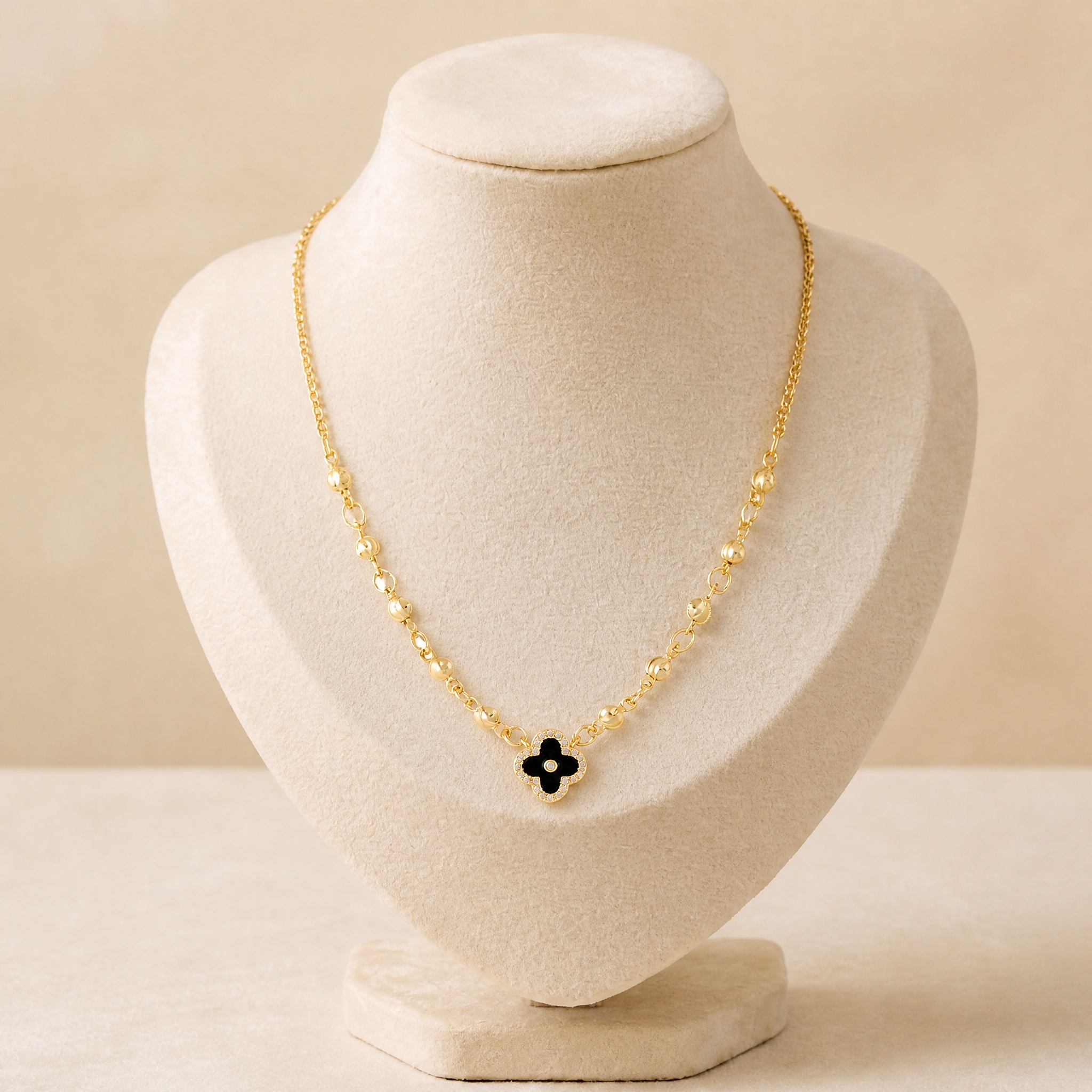 colier_trifoi_negru_bust_2 Colier placat cu aur de 14K, model celebrity cu bobițe aurii pe lanț și pandantiv trifoi negru conturat cu cristale mărunte, Noem® - imagine 1